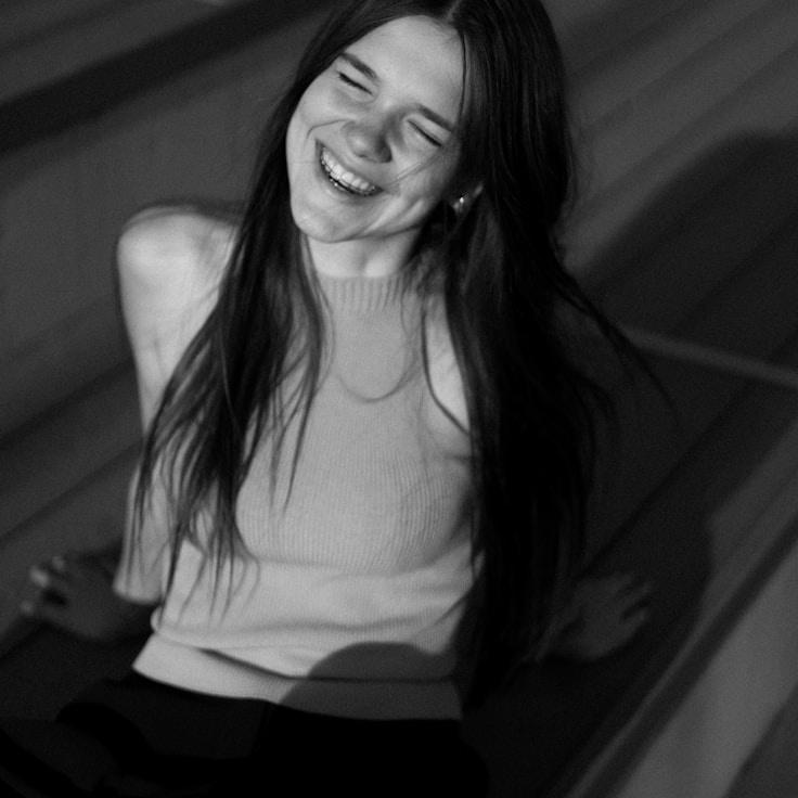 Lina Hart, Lead Design Curator at Emerald Sky Gateway, reviewing corporate floral arrangements